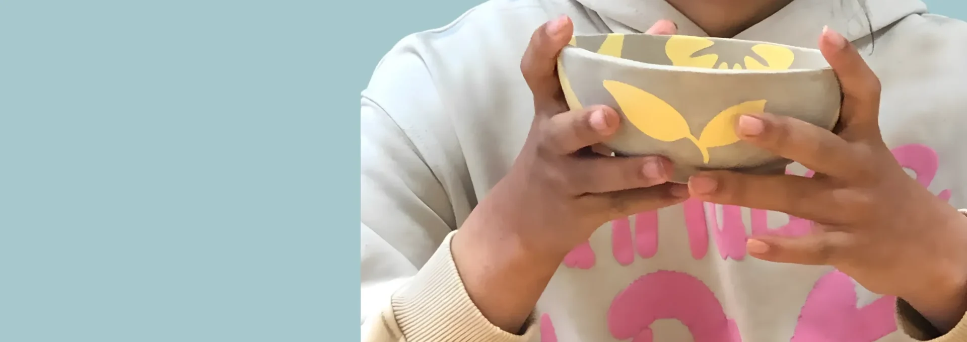 Ceramics by Madebyheroes Girl holding handcrafted ceramic bowl with flower print